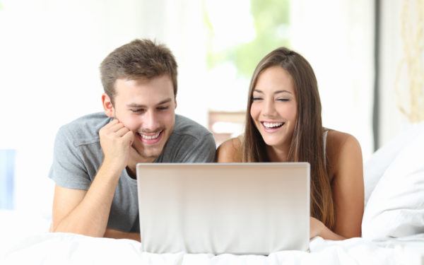 Couple watching videos on a laptop at home