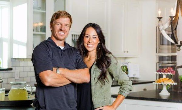 chip and joanna gaines standing in their kitchen